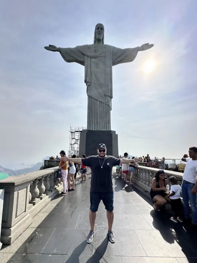 Hassan mirroring the outstretched arms of the Christ the Redeemer statue in Rio de Janeiro, Brazil